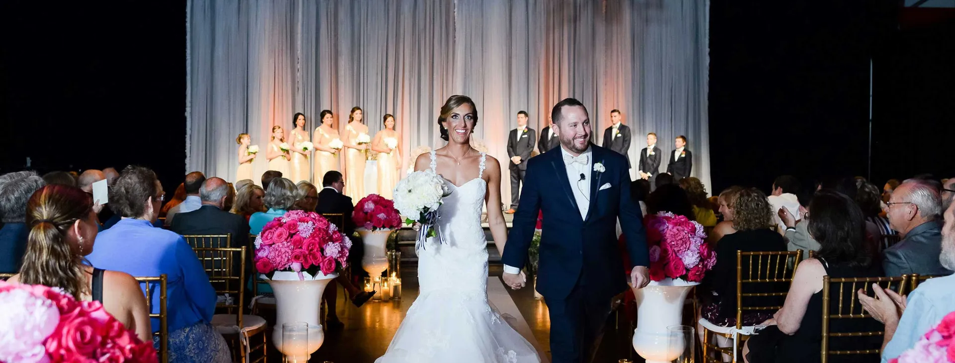 Mr. and Mrs. walking down the aisle at The Crane Bay in Indianapolis Indiana