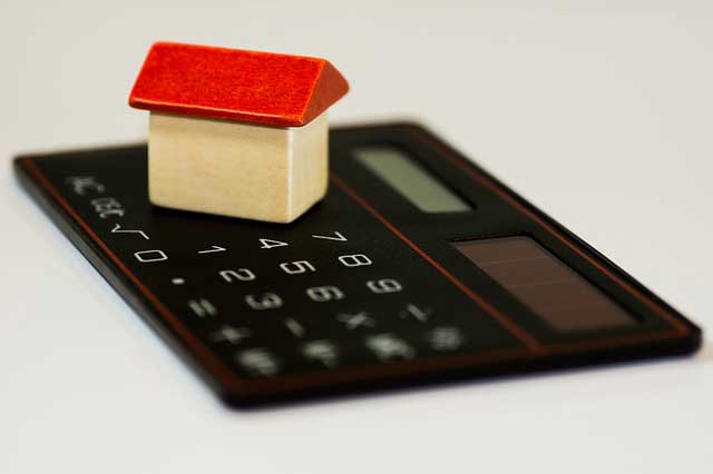A calculator and wooden block house