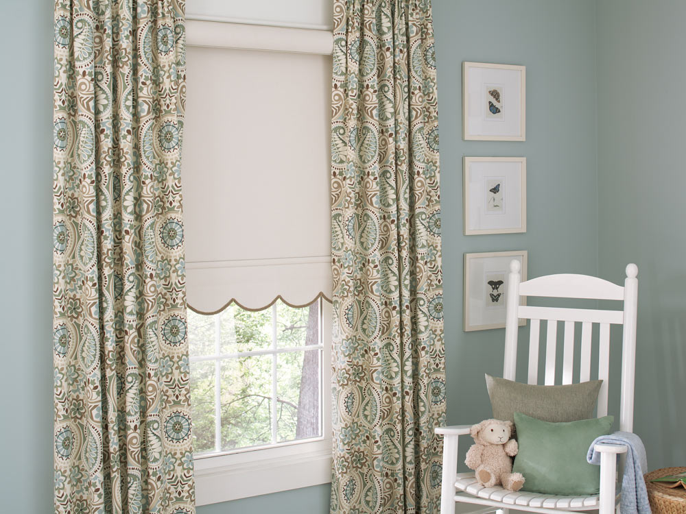 light tan Genesis® Roller Shade with Scalloped Hem, brown Decorative Trim & Interior Masterpieces® Draperies in a floral pattern against blue walls