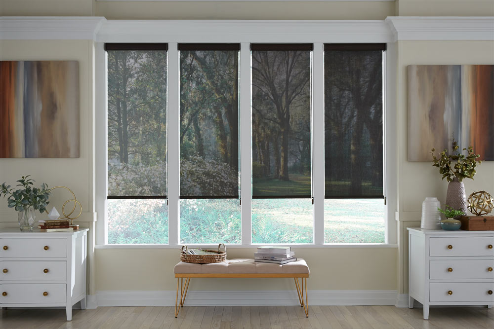 four black Genesis® Cassette Roller Shades showing different opacity levels with the lightest on the left and darkest on the right