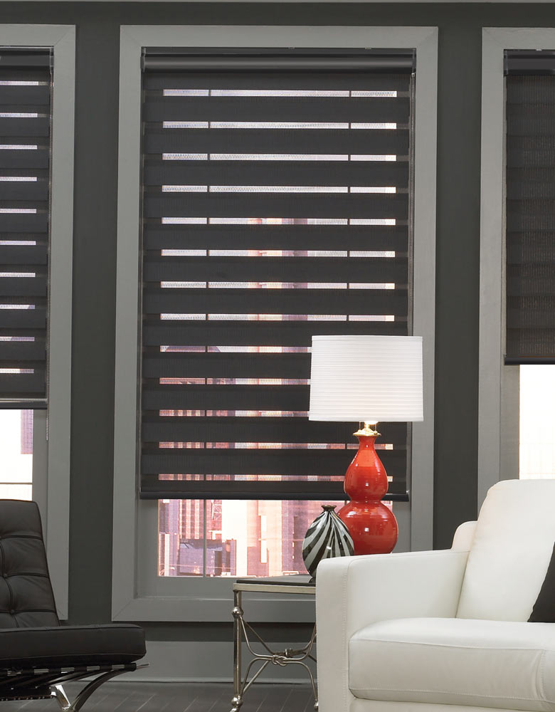 Dark Allure® Transitional Shade against a dark wall with a light gray window fram with a red lamp on a black table and white couch in front