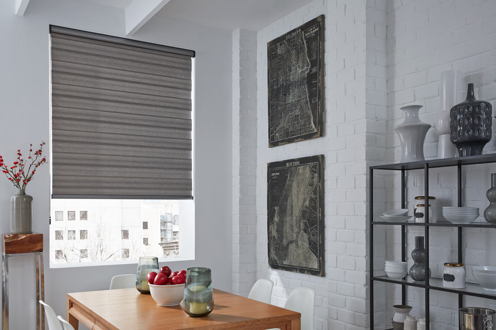 large black Allure® Transitional Shade in a kitchen with white walls and black artwork nearby and red fruit on a brown table