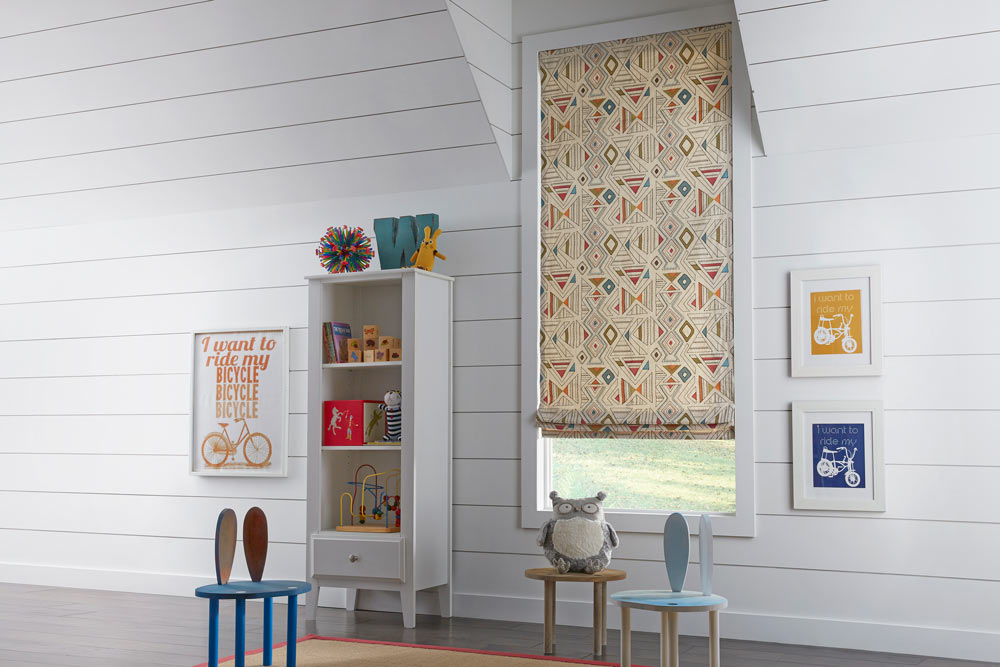 Light brown Interior Masterpieces® Fabric Shade with a geometric pattern in a child's room with little chairs and a stuffed owl sitting in front