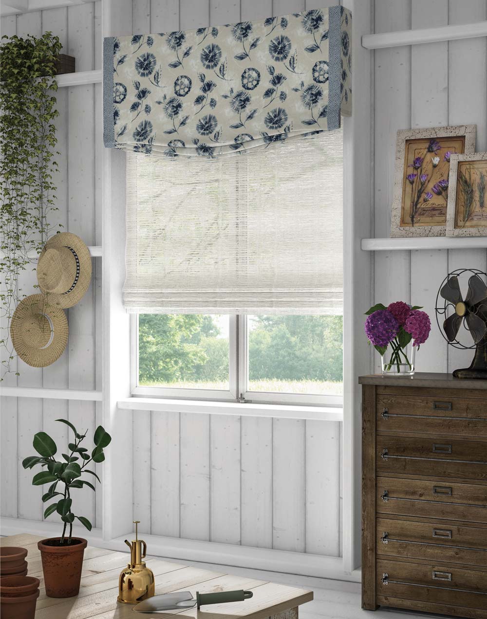 Interior Masterpieces® Custom Fabric Wrapped Cornice with white and blue floral material hanging on top of a white Woven Wood Manh Truc® Hobbled Roman Shade