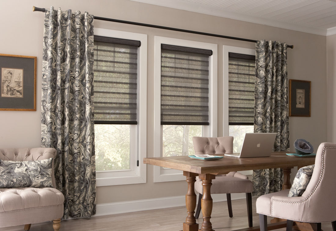 3 windows with dark Allure® Transitional Shades and Interior Masterpieces® Draperies hanging at each end on a black custom rod
