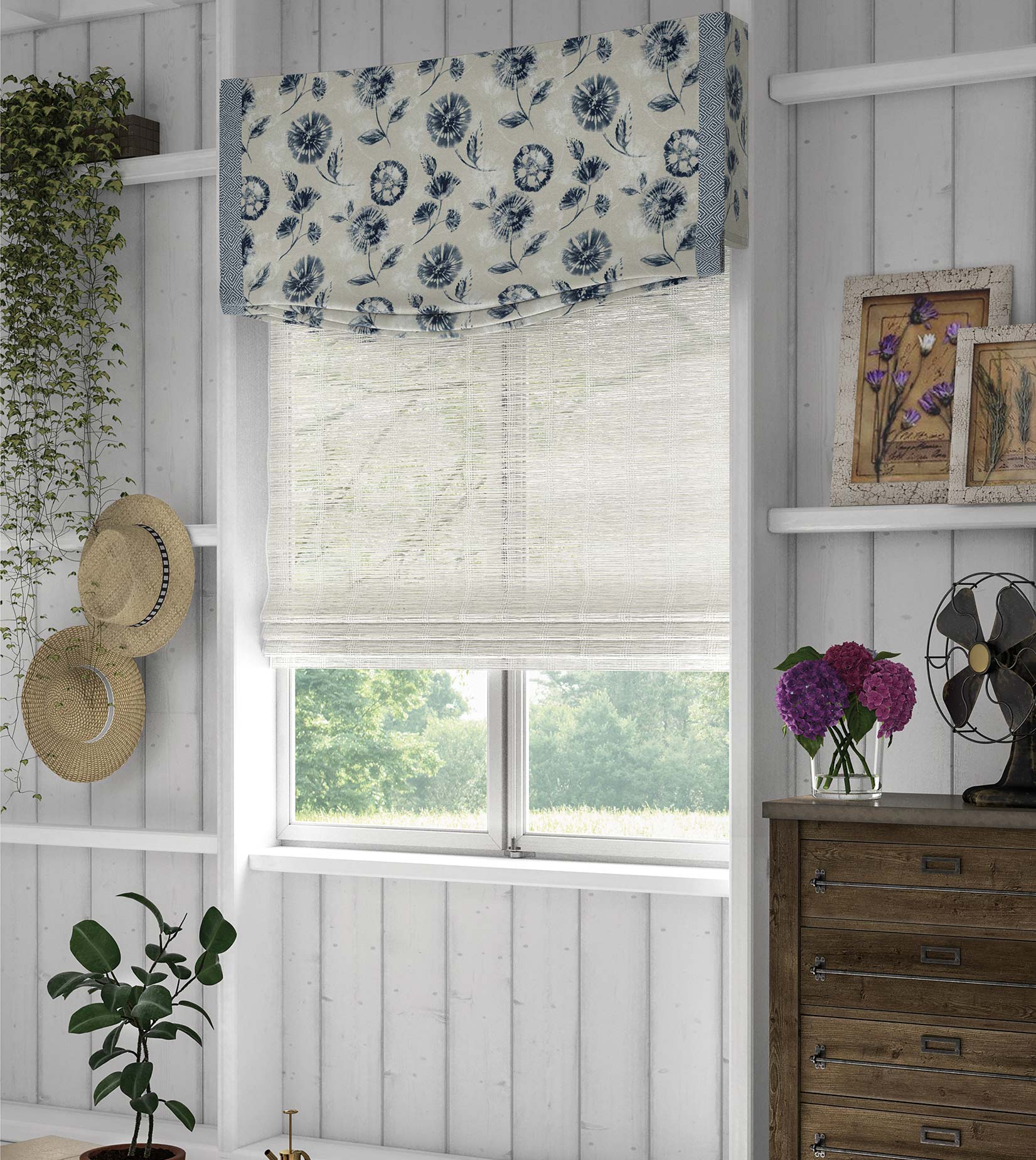 A custom fabric valance in a blue floral pattern hangs above a white woven wood fabric shade.
