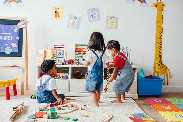 Children playing with blocks, toys and trains