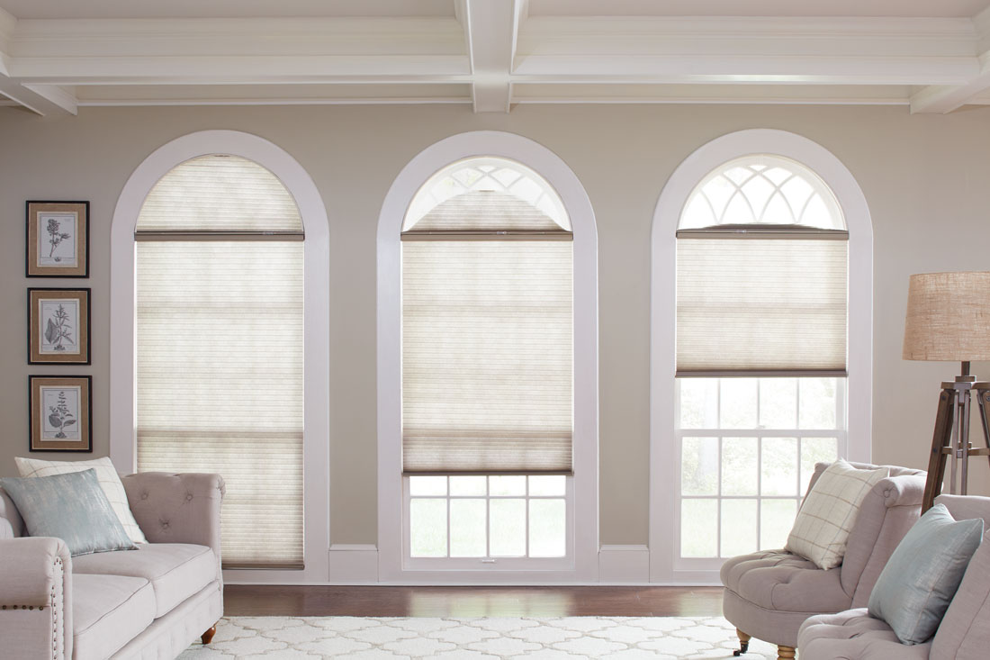 Three Parasol® Cellular shades in 3 tall windows with a rounded top that have Slide Arch Specialty Shaped Parasol® shades in them