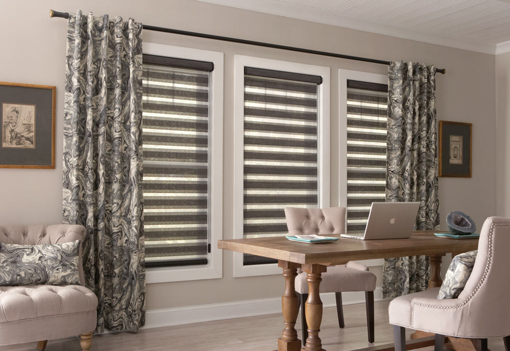 three large gray Allure® Transitional Shades in a row with inky patterned black and gray Interior Masterpieces® Draperies hanging at each end on black Custom Hardware
