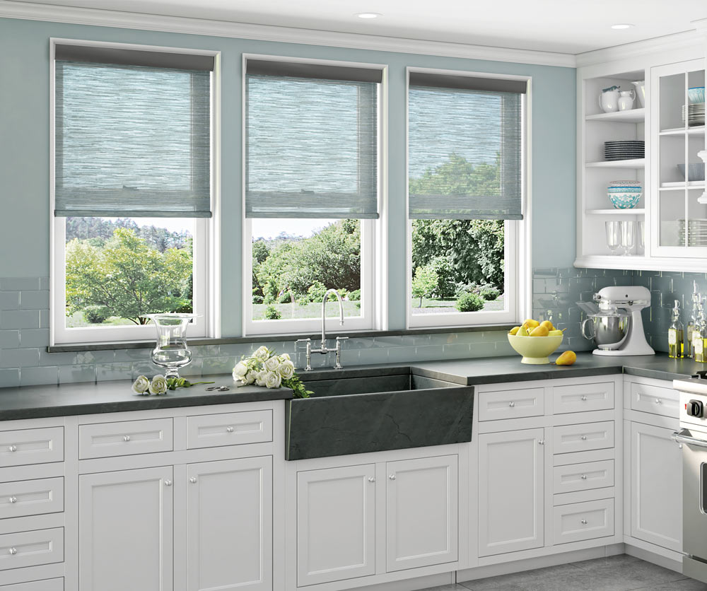 Several blue light filtering Genesis® Roller Shades in a kitchen behind the sink