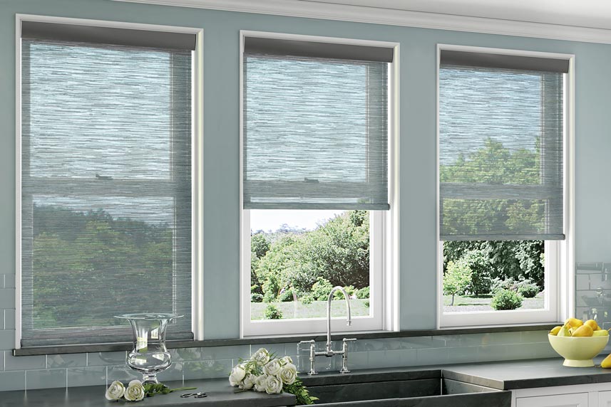 Several blue light filtering Genesis® Roller Shades in a kitchen behind the sink