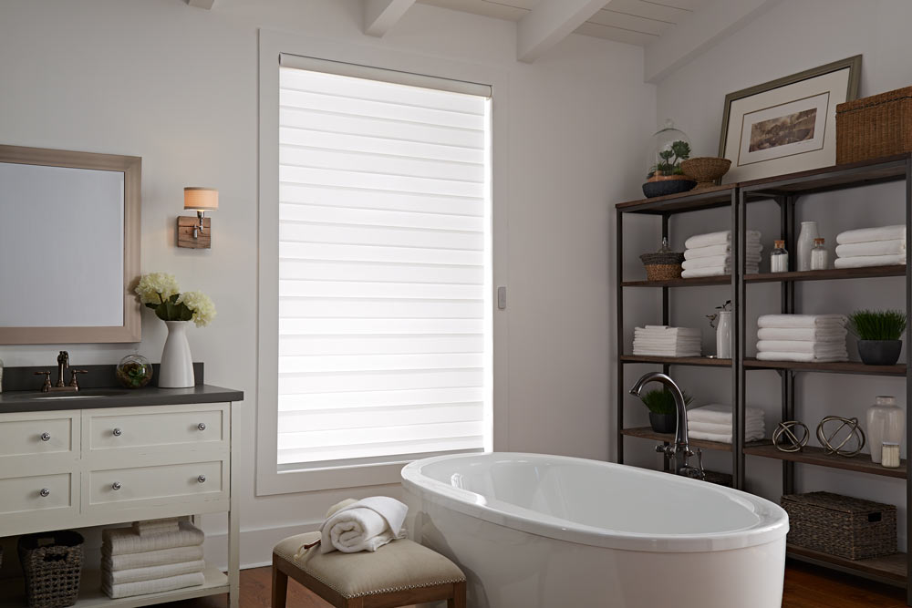 one large white Allure® Transitional Shade in a bathroom behind a stand alone tub and dark shelving