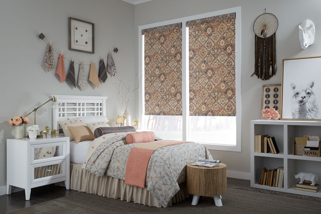 Geometric floral patterned orange and brown Interior Masterpieces® fabric shades with custom bedding on the bed in front