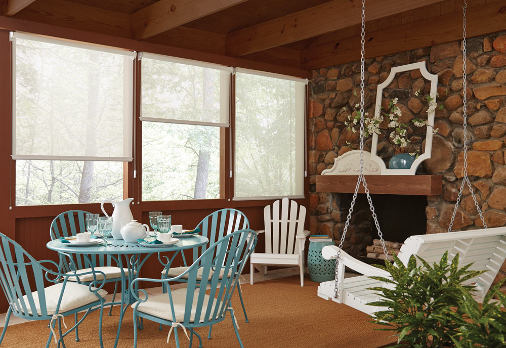 three large Genesis® Custom Roller Shades in a cabin with blue and white furniture in the foreground