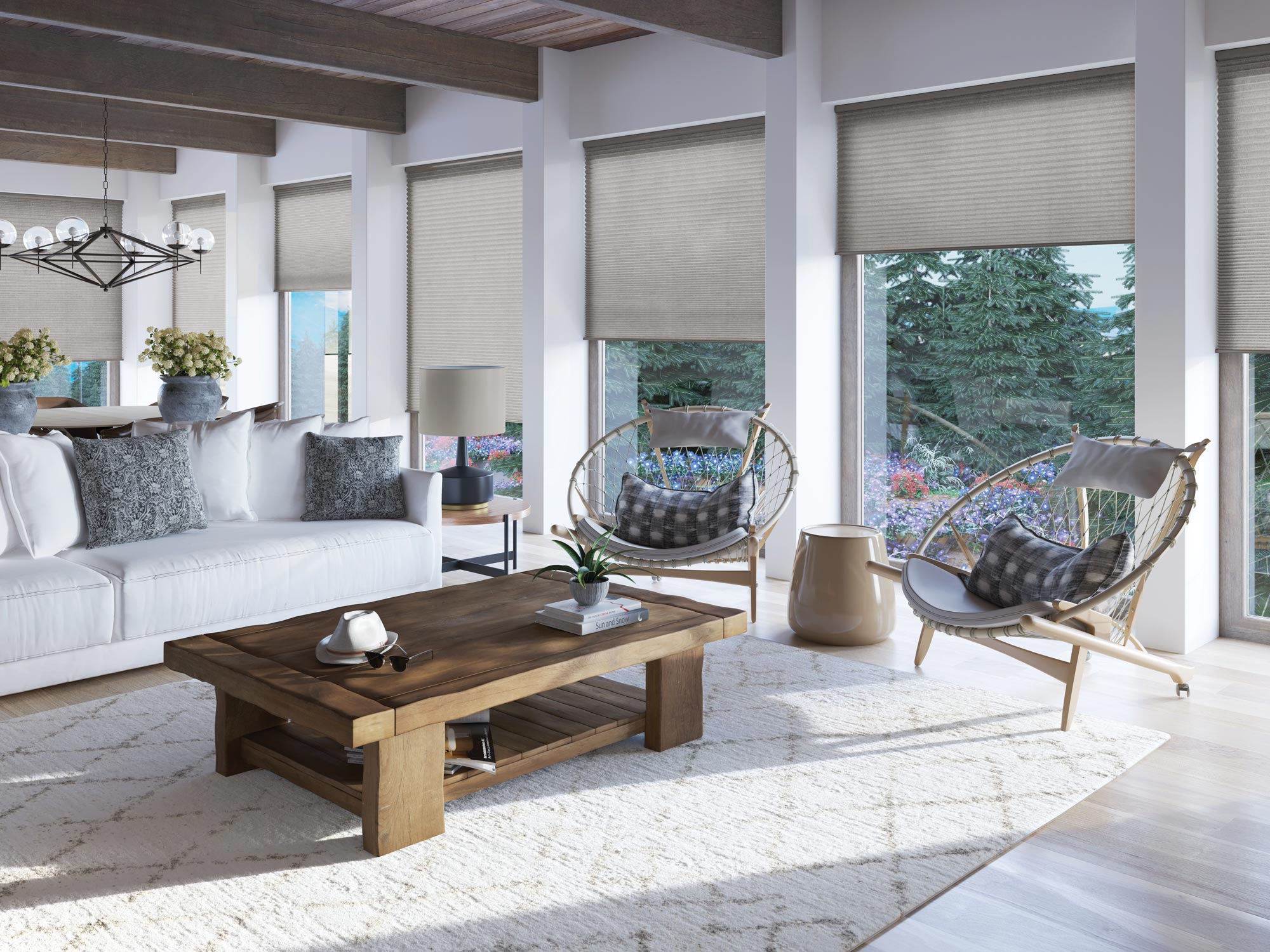 Several Parasol® Cellular Shades along a wall with trees outside and a cool interior living room inside