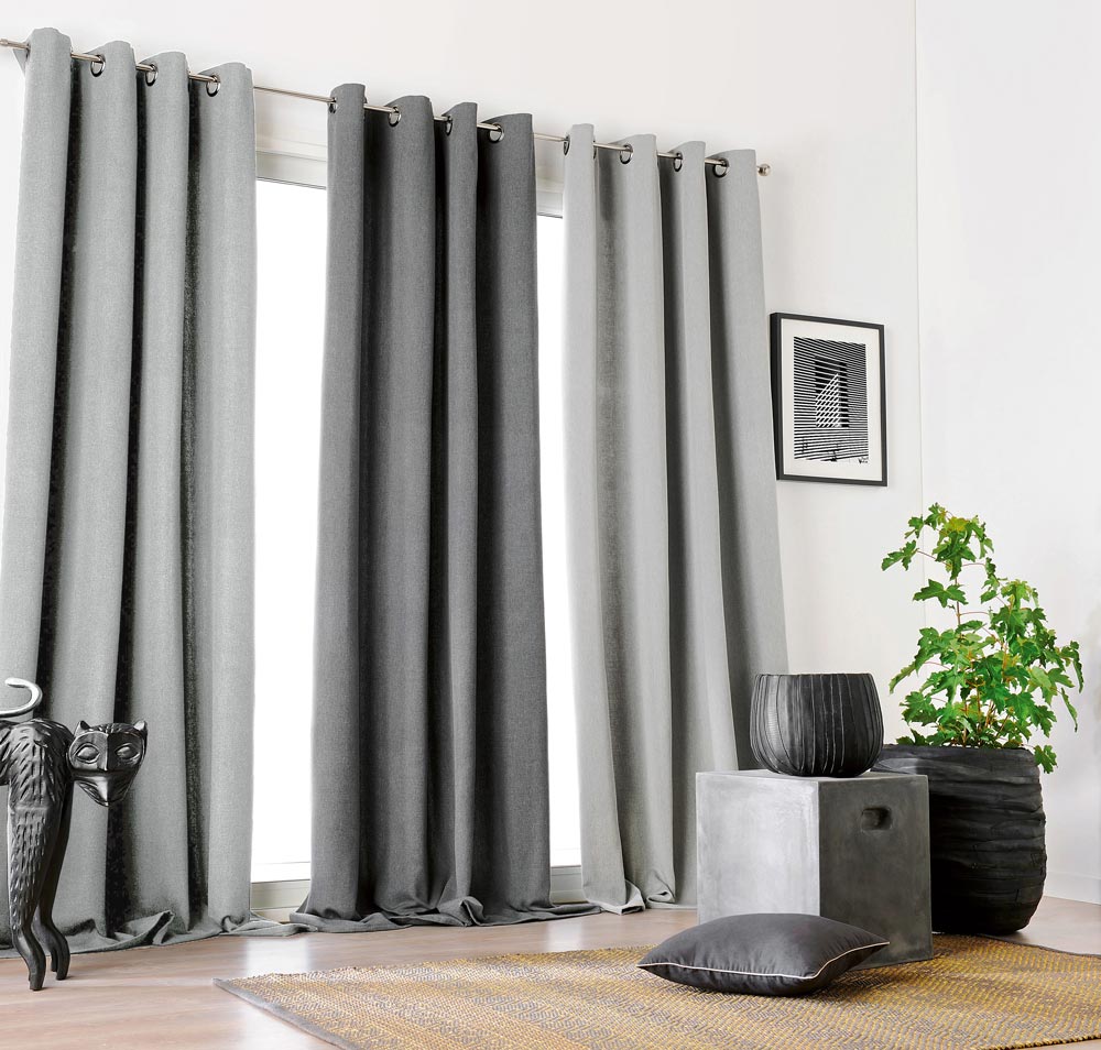 One large window with 3 Interior Masterpieces® Draperies hanging in it with light gray and dark gray
