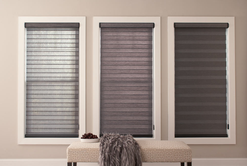 three large dark gray Allure® Transitional Shades at different opacities showing light coming through more at the left and darkening to the right