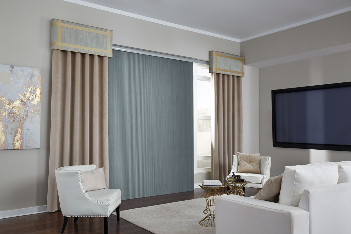 Parasol® Cellular Glissade panel system hanging in a wide window with two Custom Wrapped Cornices hanging on either end with accompanying draperies hanging down on both ends of the window