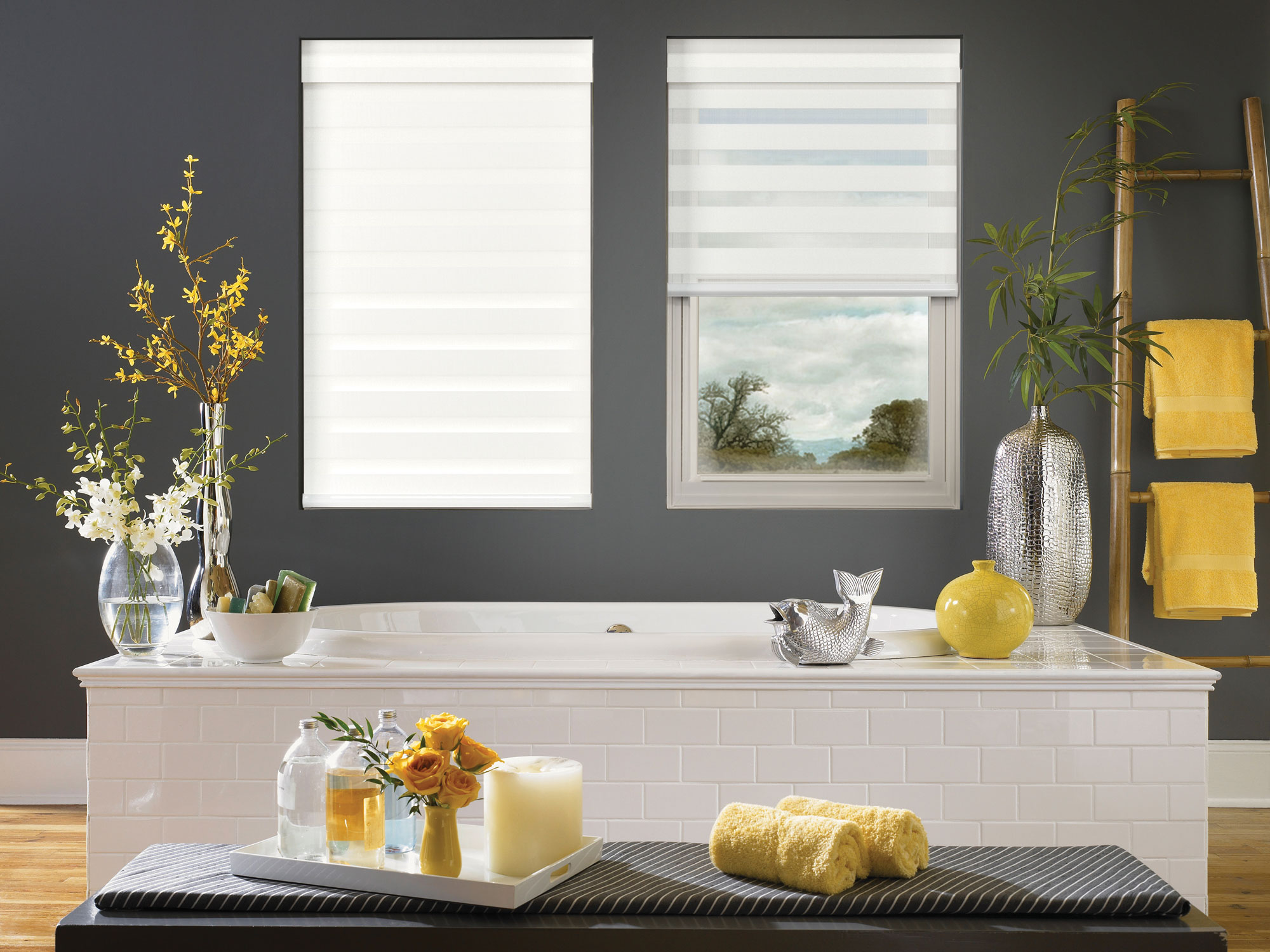 two large, white Allure® Transitional Shades behind a bathtub on a dark grey wall with several yellow accent pieces around