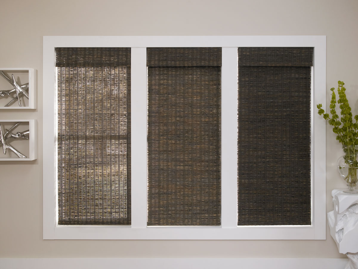 Three dark colored Manh Truc® Woven Wood Shades in Unlined, Light Filtering, and Room Darkening