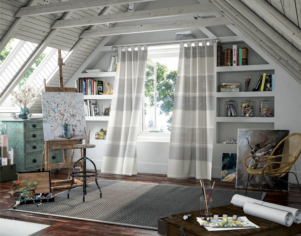 white blue and tan Interior Masterpieces® draperies hanging in an artists room with a custom rod and finials