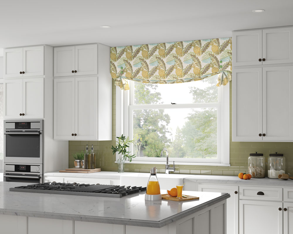 Select Masterpieces® fabric valance with yellow pineapples and leaves in a kitchen with white cabinets