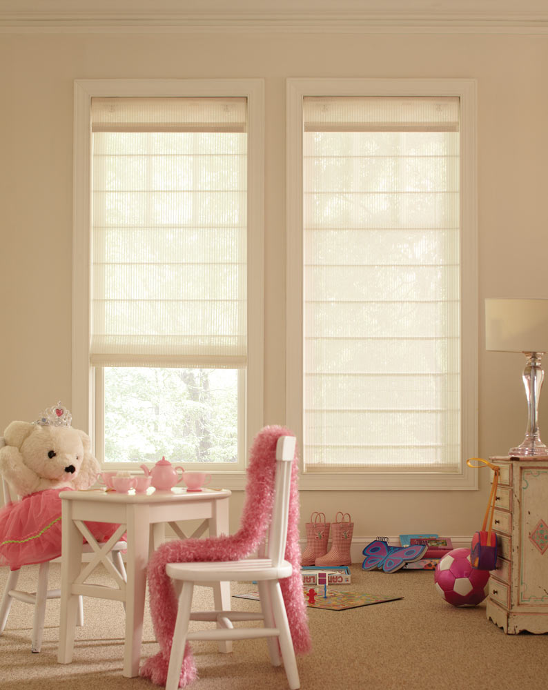 two light tan Genesis® Cordless Roller Shades in a child's room with a stuffed teddy bear at a table with a pink tea set