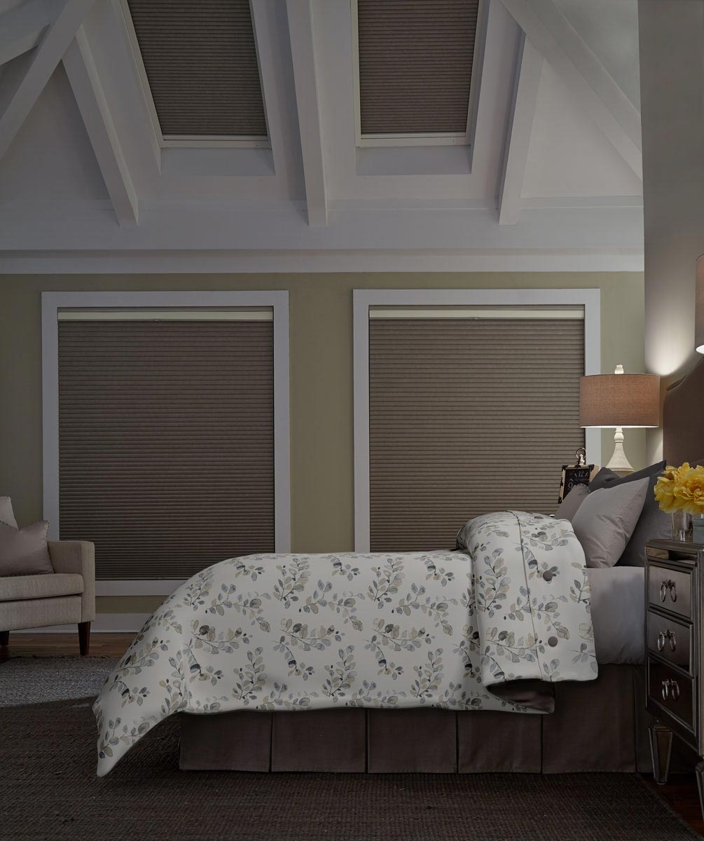 Parasol® Cellular Shades in the closed position in windows behind a bed with Interior Masterpieces® custom bedding