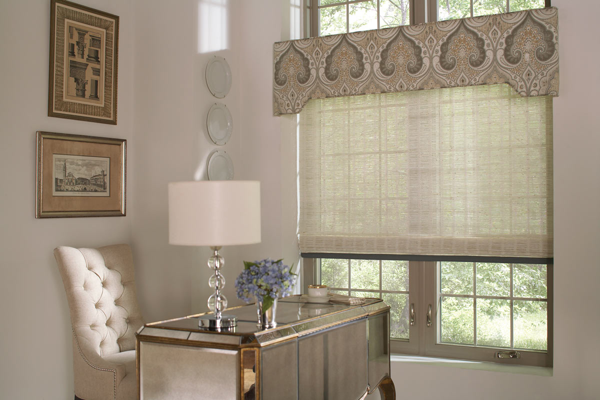 tan colored Manh Truc® Woven Wood Shades with blue Banding & light brown patterned Interior Masterpieces® Fabric Cornice