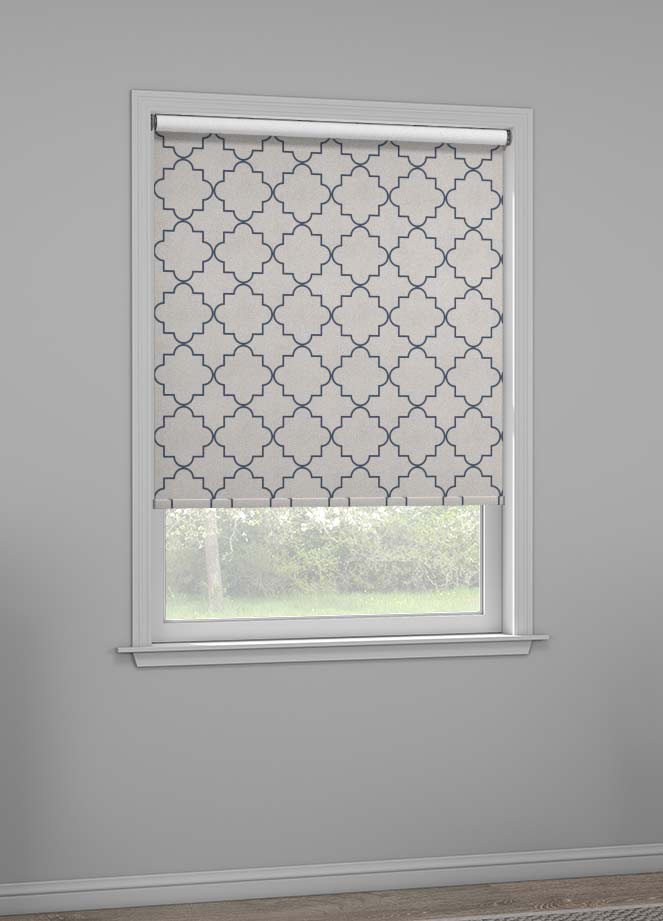 A grey shade with a navy geometrical pattern called symmetry hangs in a window.