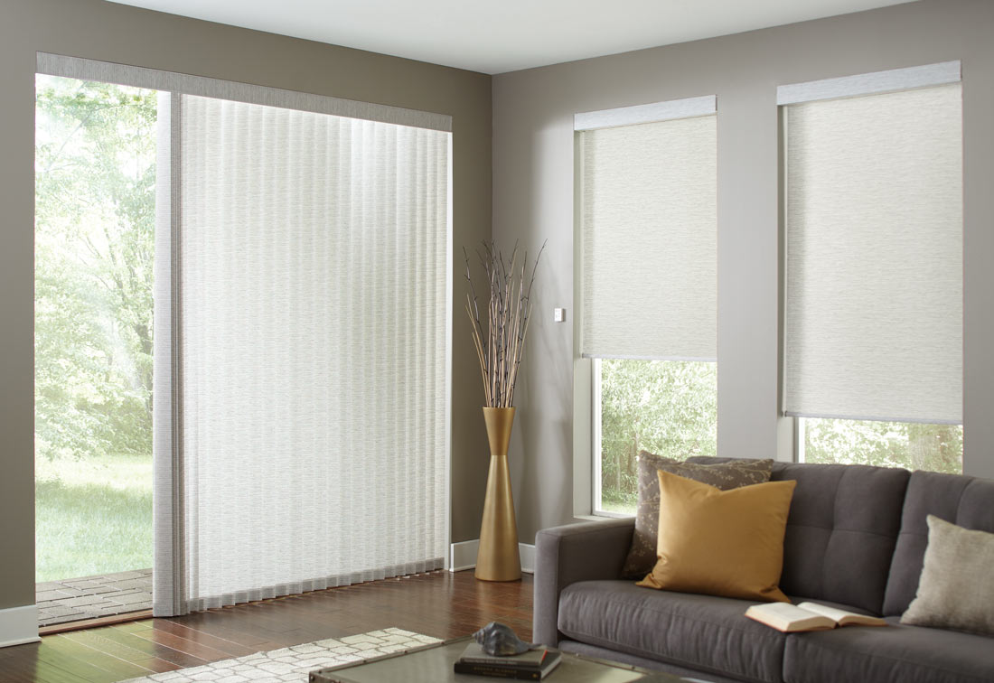 several off white Genesis® Roller Shades and matching Sheer Visions® Vertical Blinds on a large opening on the adjoining wall