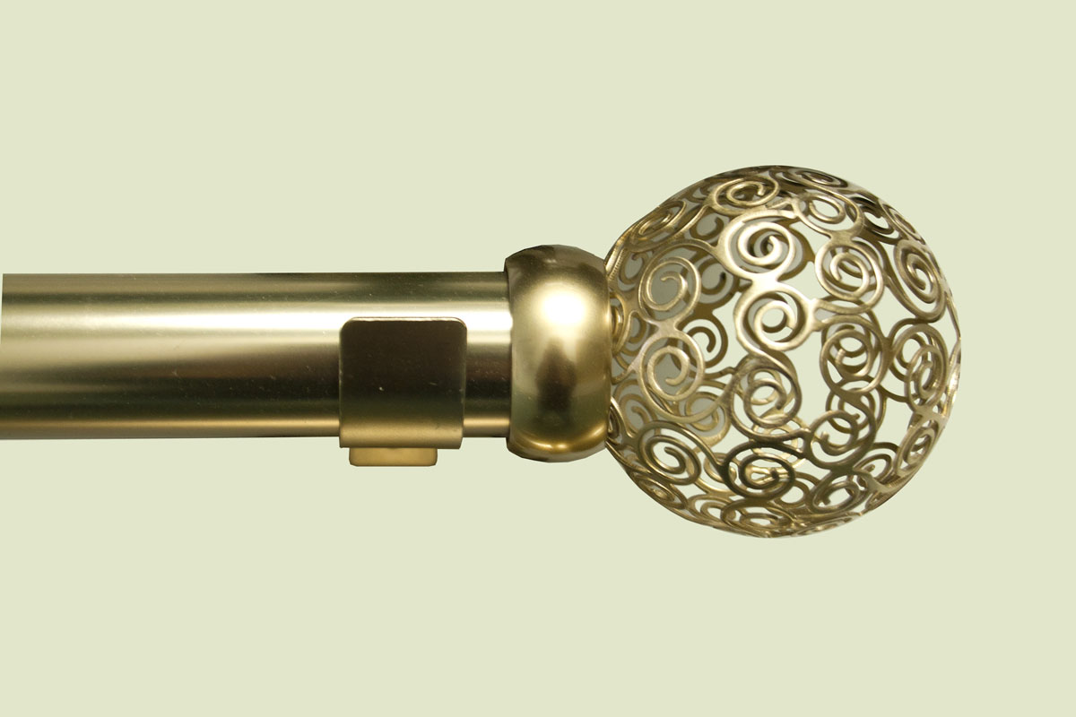 closeup view of golden custom rod with a finial that is made up of tiny swirls