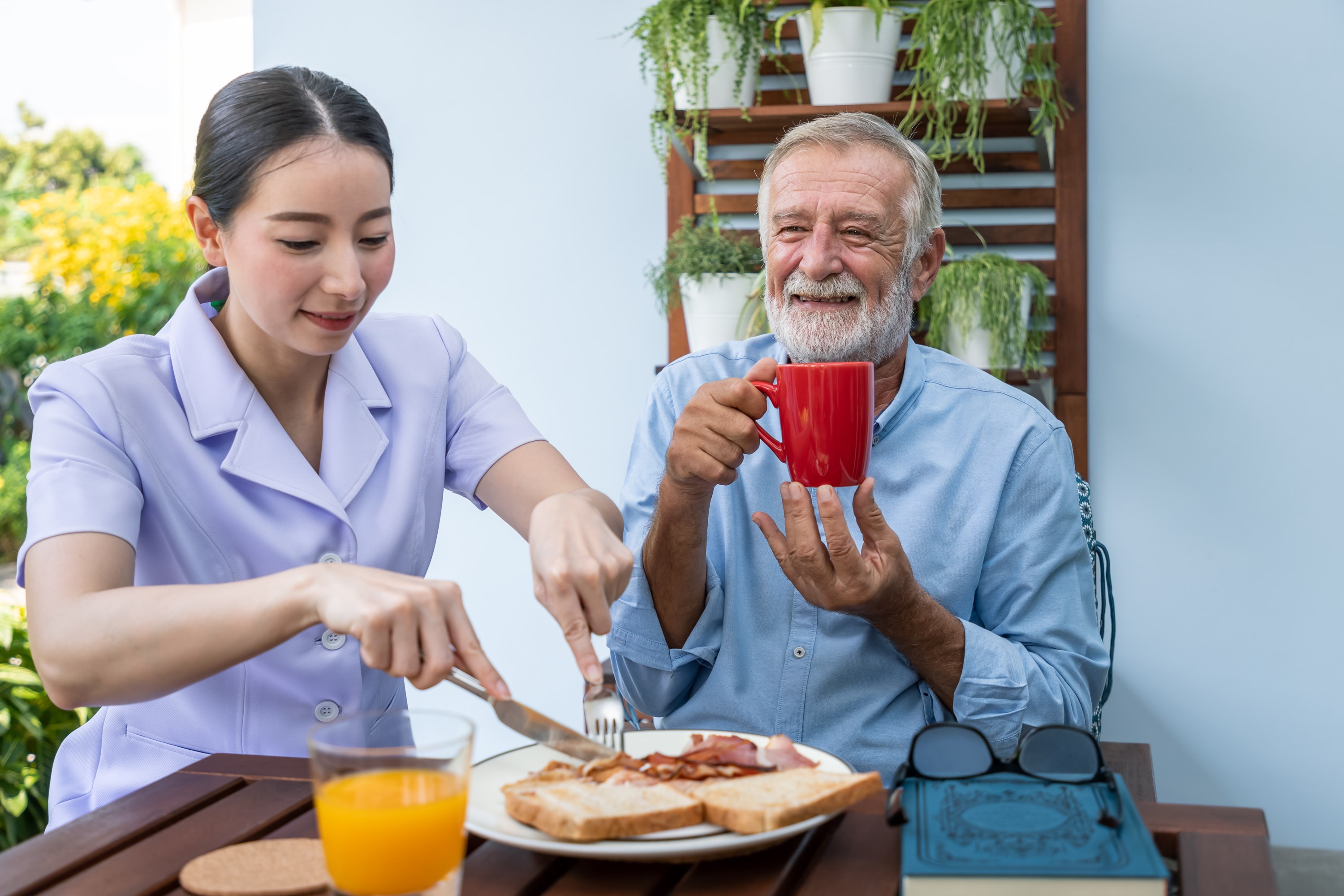 nurse-assist-elderly-senior-man-eat-breakfast-drink-coffee-with-mug-hand-nursing-home