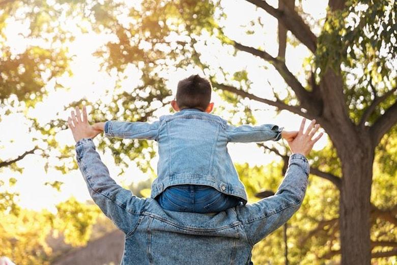 medium-shot-man-holding-kid-shoulders_23-2149235070