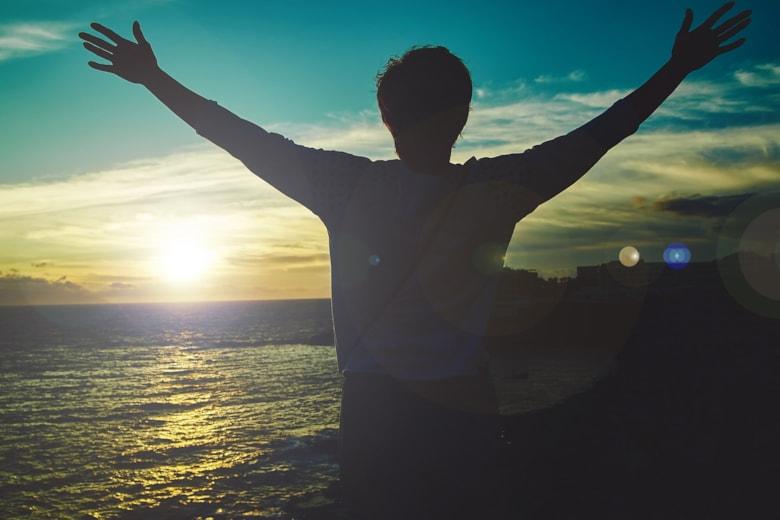 young-woman-with-raised-hands-greeting-sun_158538-14463