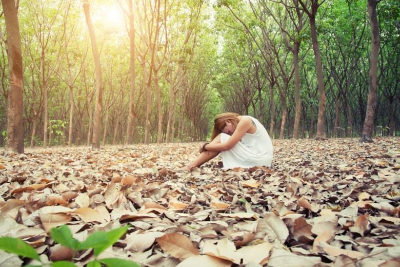 woman-sitting-with-her-head-resting-her-knees_1150-332