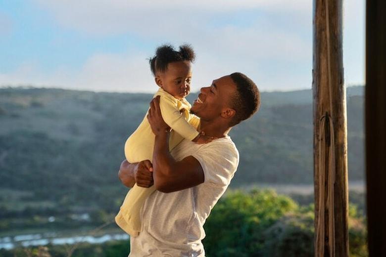 cute-black-baby-home-with-parents_23-2149618891