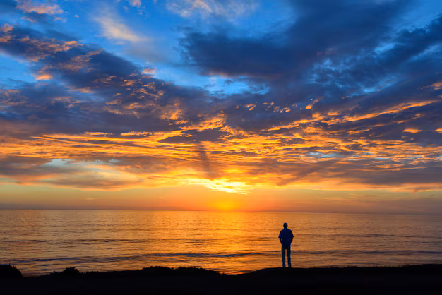 silhouette-person-standing-beach-cloudy-sky-breathtaking-sunset_181624-13424.jpg