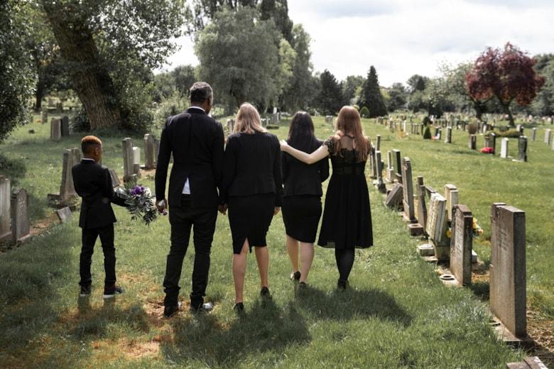 family-visiting-grave-loved-one_23-2149125580