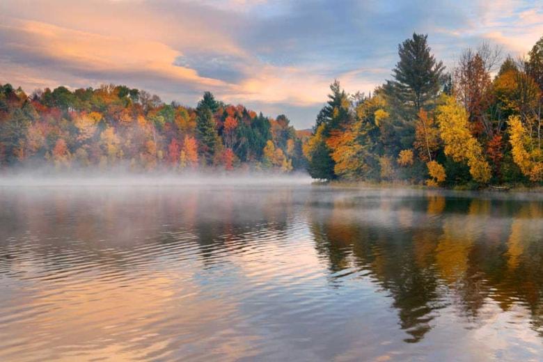 lake-fog-sunrise-with-autumn-foliage-mountains-new-england-stowe