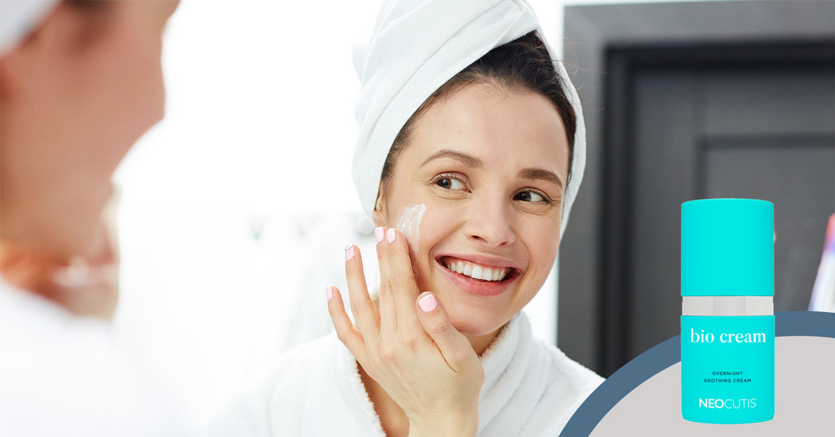 Woman applying Biocream by Neocutis as part of her nightly skin care routine