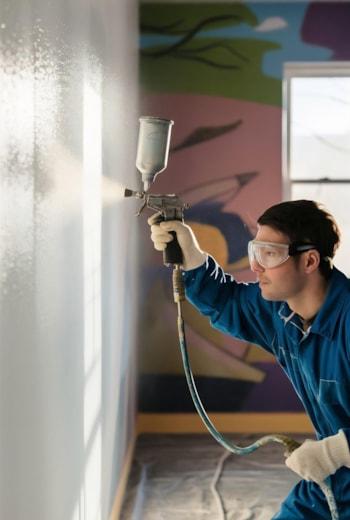 worker-painting-wall-with-spray-gun-white-color worker-painting-wall-with-spray-gun-white-color