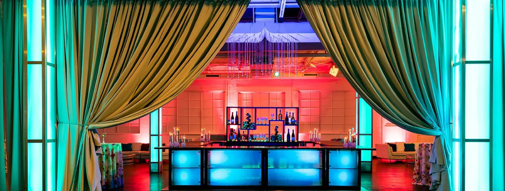 Curtains drawn back as if to reveal the bar at The Crane Bay in downtown Indianapolis
