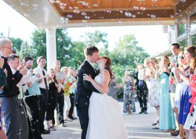 Bride and Groom kissing in front of The Ballroom at The Willows at their wedding reception