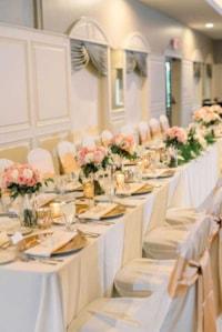 Family-style seating arrangement for an elegant wedding reception in The Ballroom at The Willows