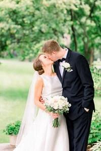Travis and Kathleen kissing after their wedding ceremony in Broad Ripple at St. Pius