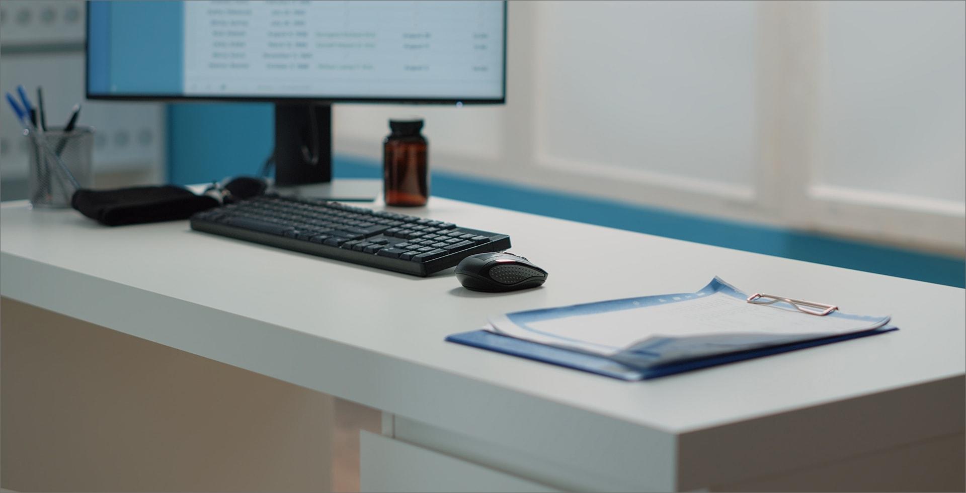 close-up-desk-with-medical-documents-computer-empty-doctors-office-nobody-cabinet-with-keyboard