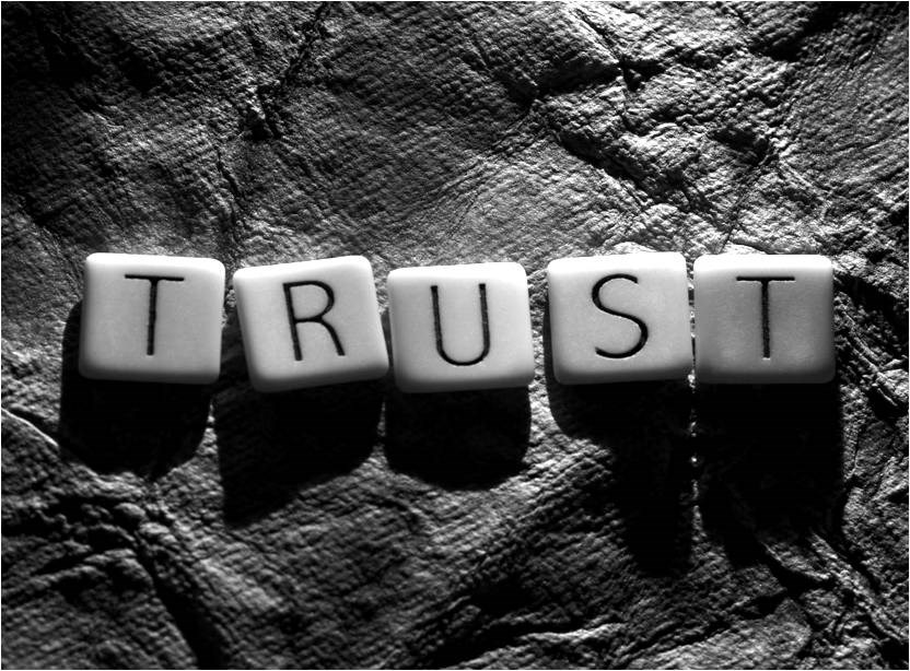 Scrabble tiles spelling "Trust"