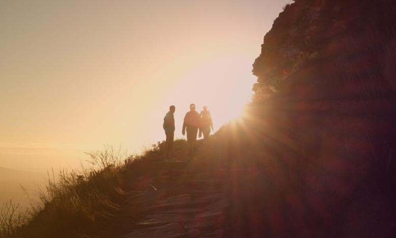 Sun rising on a group of hikers is like acknowledging the shadow existing in an organization