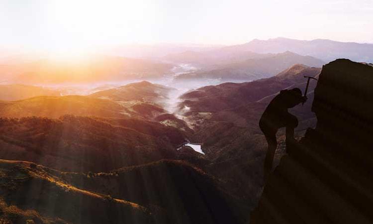 Man climbing to the top toward success